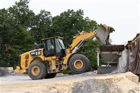 Rahns Concrete: A Caterpillar 966M loads concrete sand into one of the portable ready mix plant hoppers. 