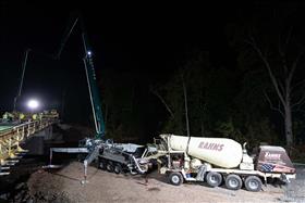 Rahns Concrete: A Rahns Concrete front discharge mixer truck feeds product into a pump truck for a bridge deck pour. 